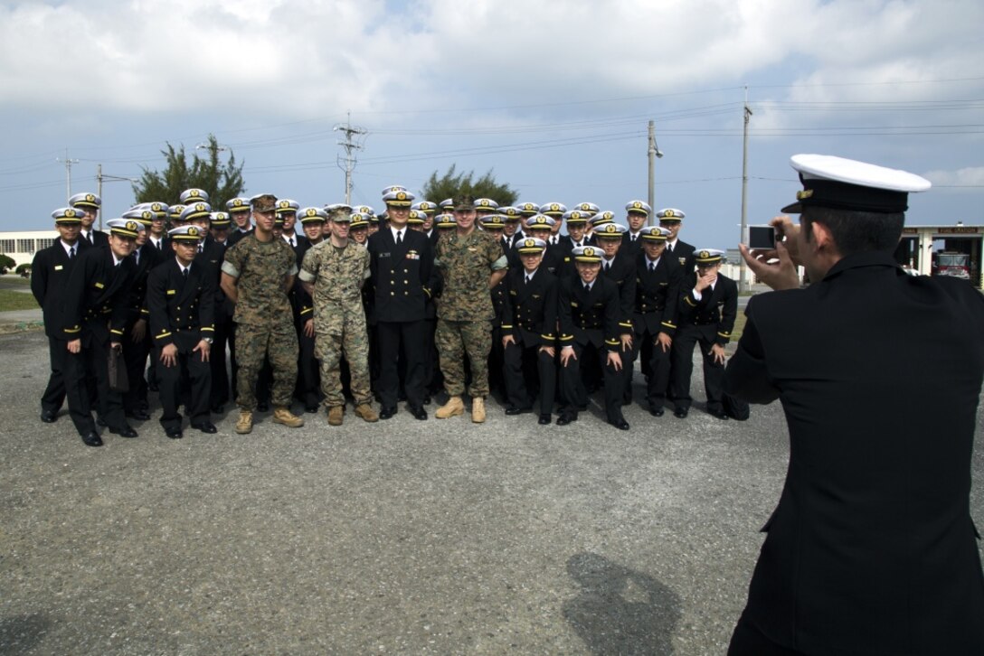 MCAS FUTENMA, OKINAWA, Japan – Marines and officer candidates pose for a group photo March 24 on Marine Corps Air Station Futenma, Okinawa, Japan. The candidates with the Japan Maritime Self-Defense Force received a brief on the cooperation between Marines and the Japan Self-Defense Force and the crucial role MCAS Futenma plays. (U.S. Marine Corps photo by Cpl. Jessica Collins)