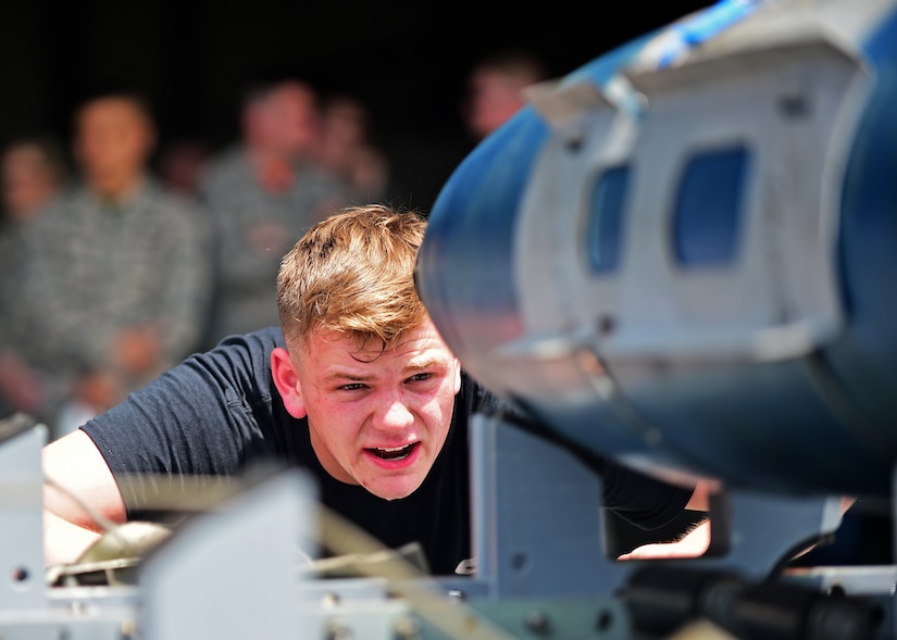 U.S. Air Force Airman 1st Class Zachary Semmer, 27th Aircraft Maintenance Unit weapons crew member, helps load munitions onto a rack during the 1st Maintenance Group Load Crew of the Quarter competition at Joint Base Langley-Eustis, Va., April 28, 2017. The event was dedicated to Senior Airmen Sara Toy and Austin Terrell, and Staff Sgt. Alexandria Morrow, who passed away and were members of weapons community. 