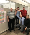Members of the “Award Rabbits” team pose April 19 with their trophy after winning a March Madness-styled contract purchase request competition within the DLA Troop Support Industrial Hardware supply chain. Standing are, from left to right, Donald Barrella, Michelle Gemmell and Ken Price. Kneeling are Luke Peeling and John Logan. Team members not pictured are Charmaine Ford, Kiriroth Lor and Yasmin Dossa, team coach.