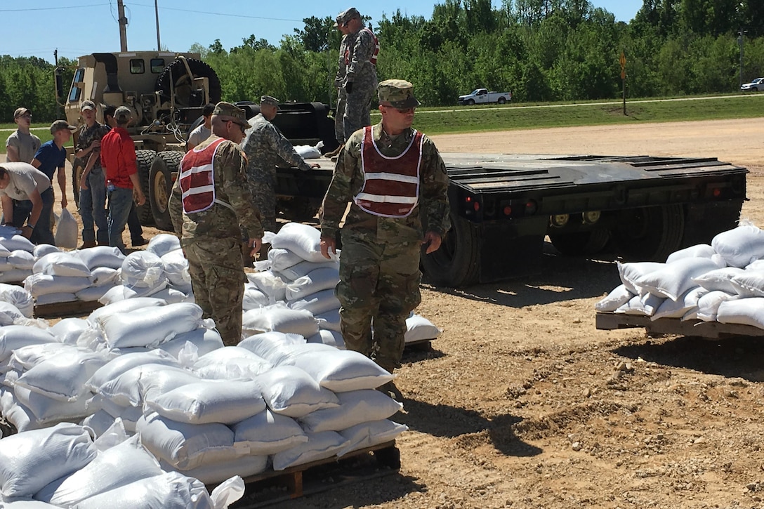 Missouri National Guardsmen and JROTC members fill sandbags to help with flooding relief in Poplar Bluff, Mo., May 2, 2017. The guardsmen are assigned to the 1138th Engineer Company, Farmington Mo., and the 294th Engineer Company.  Air National Guard photo by Senior Master Sgt. Mary-Dale Amison