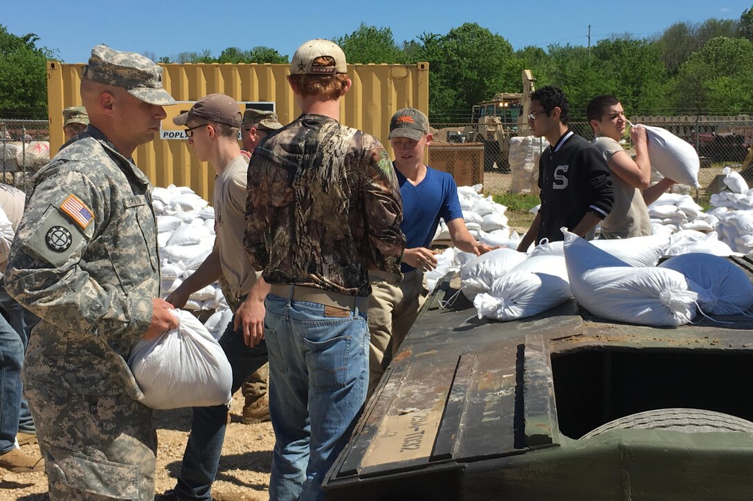 Missouri National Guardsmen and JROTC members fill sandbags to help with flooding relief in Poplar Bluff, Mo., May 2, 2017. The guardsmen are assigned to the 1138th Engineer Company, Farmington Mo., and the 294th Engineer Company.  Air National Guard photo by Senior Master Sgt. Mary-Dale Amison