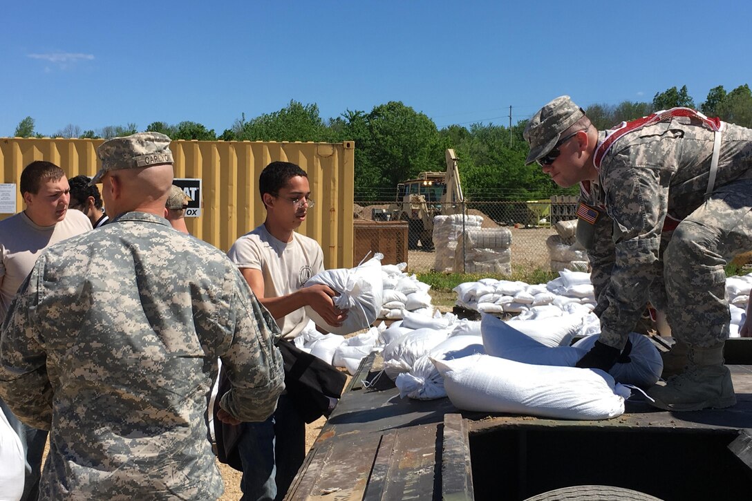 Missouri National Guardsmen and JROTC members fill and carry sandbags to help with flooding relief in Poplar Bluff, Mo., May 2, 2017. The guardsmen are assigned to the 1138th Engineer Company, Farmington Mo., and the 294th Engineer Company.  Air National Guard photo by Senior Master Sgt. Mary-Dale Amison