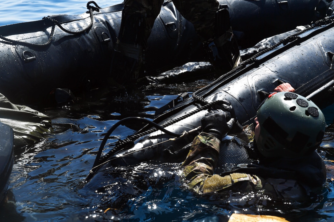 A Greek paratrooper inflates a Zodiac raft during Exercise Stolen Cerberus IV near Elefsis Air Base, Greece, April 27, 2017. The raft was dropped and six Greek paratroopers jumped from a U.S. Air Force C-130J Super Hercules into the Mediterranean Sea during the operation. About 110 airmen and three C-130s assigned to the 37th Airlift Squadron participated in the exercise with Greek airmen and U.S. soldiers from April 18-28. Air Force photo by Senior Airman Tryphena Mayhugh