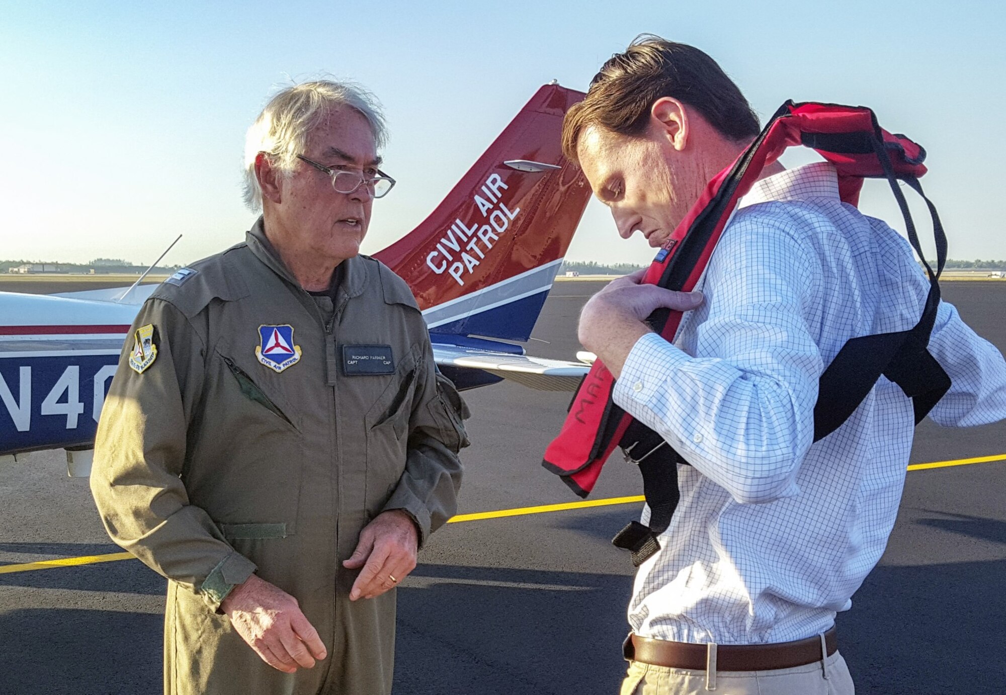 Civil Air Patrol mission pilot Capt. Richard Farmer, a member of the Florida Wing’s Marco Island Senior Squadron, briefs WPTV reporter Charlie Keegan on safety procedures for a NORAD intercept exercise over south Florida. Photo by CAP Lt. Col. Jeff Carlson