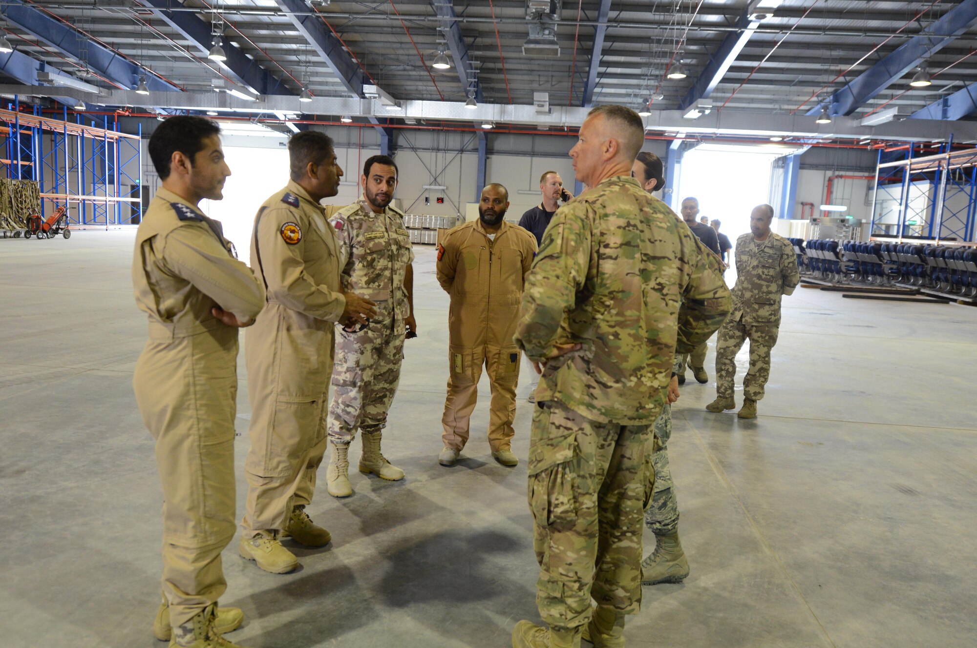 Qatari officials greet U.S. Air Force Lieutenant Colonel Robert Magee, squadron commander for the 8th Expeditionary Air Mobility Squadron (facing away from the camera), inside a newly constructed Qatari facility located at Al Udeid Air Base, Qatar, April 26, 2017. The Qatari officials and Macgee met inside the facility to observe a training exercise kicking off collaboration between the Qatari Air Force and the U.S. air force. (U.S. Air Force photo by Tech. Sgt. Bradly A. Schneider)