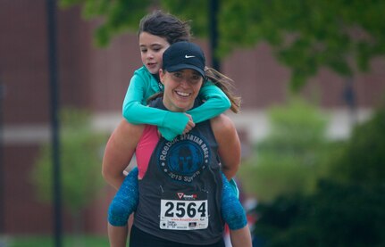 Stephanie Casado, temporary coordinator of the Veterans Affairs department at Kutztown University, “rucks” with her daughter Maya during the fourth annual Keystone Warrior 5k Run/Walk at Kutztown University. The event, which serves as MCKU's primary fundraiser, directs up to 98 percent of proceeds to wounded veterans in Pennsylvania.