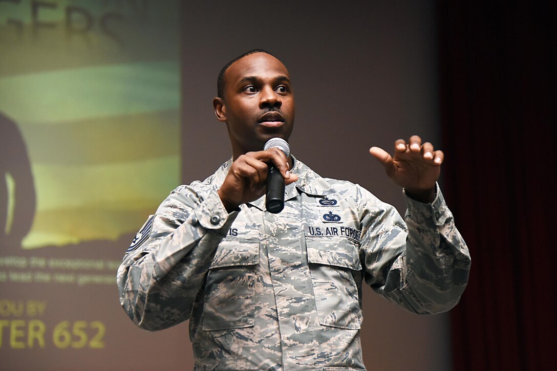 Air Force Tech. Sgt. Glenn Davis welcomes airmen assigned to the 81st Training Group to the Airmen Building Airmen Symposium at the Welch Theater at Keesler Air Force Base, Miss., April 21, 2017. The Air Force Sergeants Association Chapter 652 sponsored the event, which was designed to inspire young airmen and help them develop their leadership skills. Davis is the 335th Training Squadron personnel apprentice course noncommissioned officer in charge. Air Force photo by Kemberly Groue