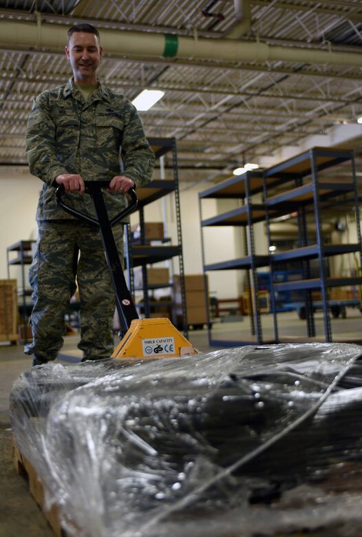 U.S. Air Force Lt. Col. Alex Mol, 733rd Logistics Readiness Squadron commander, lifts a pallet of tires at Joint Base Langley-Eustis, Va., April 18, 2017. The 733rd LRS manages logistics programs for JBLE and supports vehicle management, supply, fuels and mobility operations for installation and tenant activities.  (U.S. Air Force photo/Tetaun Moffett)