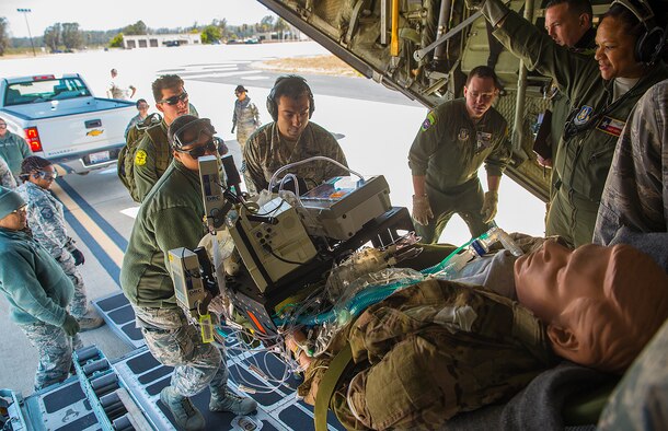 A simulated critical care patient is loaded onto a C-130 Hercules aircraft from Youngstown Air Reserve, Ohio by Airmen with the 433rd Aeromedical Evacuation Squadron during exercise Patriot Hook April 28, 2017 at Vandenberg Air Force Base, California. Patriot Hook is an annual joint-service exercise coordinated by the Air Force Reserve, designed to integrate the military and first responders of federal, state and local agencies by providing training to mobilize quickly and deploying in military aircraft in the event of a regional emergency or natural disaster. (U.S. Air Force photo by Benjamin Faske)