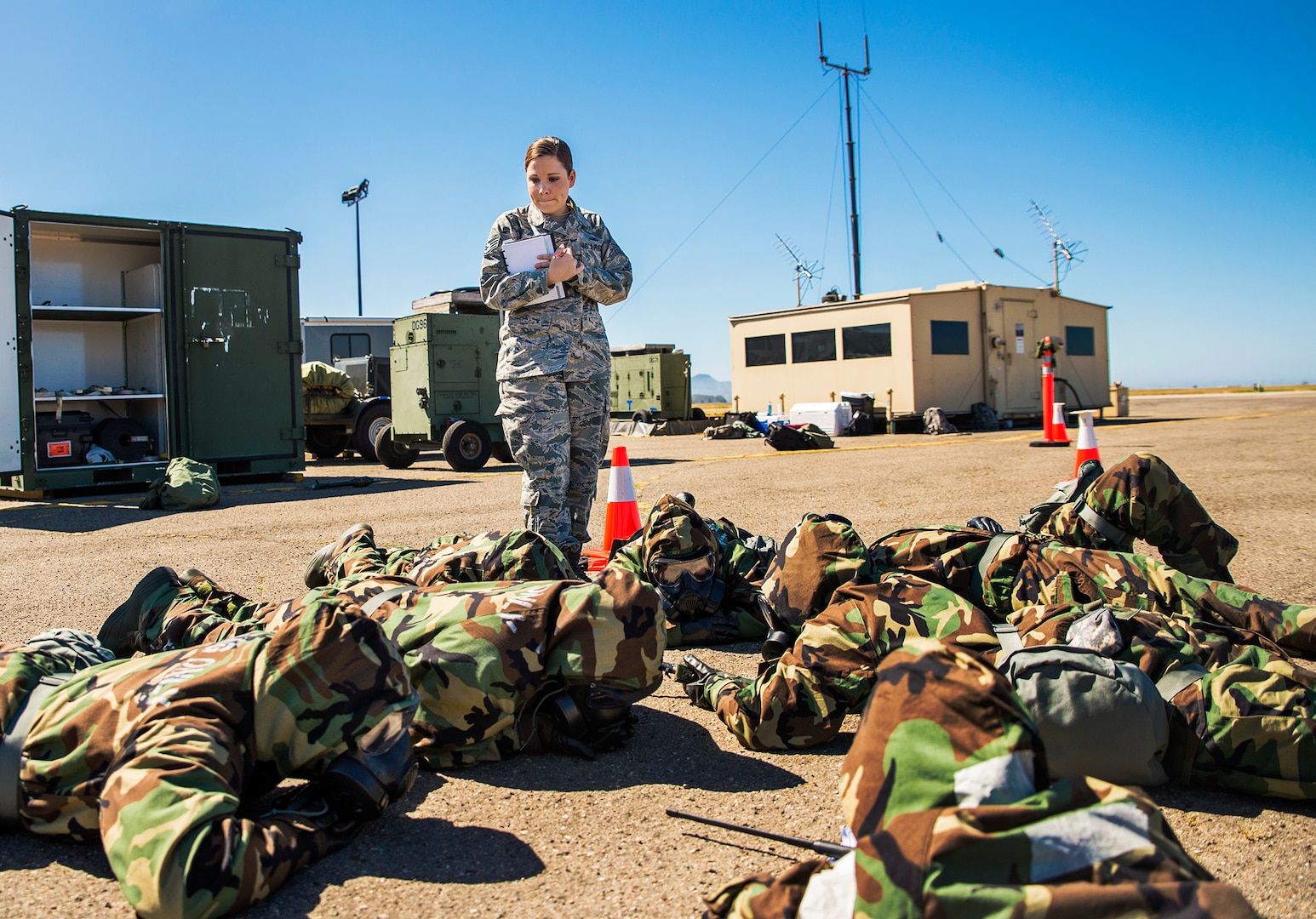 Staff Sgt. Amy Dennis, 433rd Contingency Response Element emergency management representative, inspects Airmen in Mission Oriented Protective Posture Level 4 during exercise Patriot Hook April 30, 2017 at Vandenberg Air Force Base, California. Patriot Hook is an annual joint-service exercise coordinated by the Air Force Reserve, designed to integrate the military and first responders of federal, state and local agencies by providing training to mobilize quickly and deploying in military aircraft in the event of a regional emergency or natural disaster. (U.S. Air Force photo by Benjamin Faske)