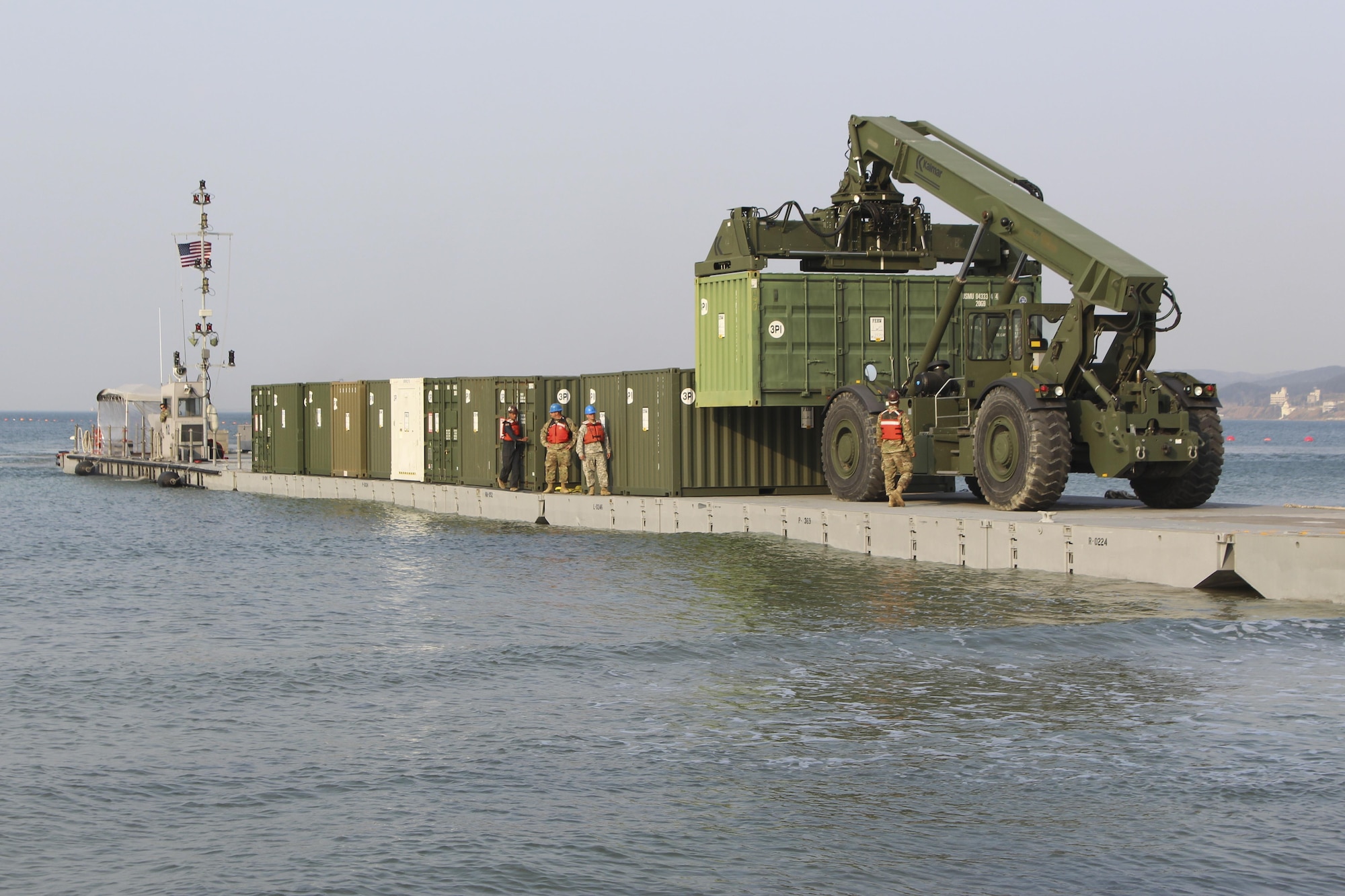 Members of the 7th Transportation Brigade (Expeditionary), 10th Transportation Battalion conduct bare-beach operations, offloading equipment off of an Army causeway ferry during the Combined Joint Logistics Over-the-Shore 2017 exercise in Pohang, South Korea, April 13, 2017. This year’s CJLOTS training fell underneath Operation Pacific Reach, a training event designed to ensure readiness and sustain allied capabilities. (U.S. Army photo/Capt. Derrick Dixon) 