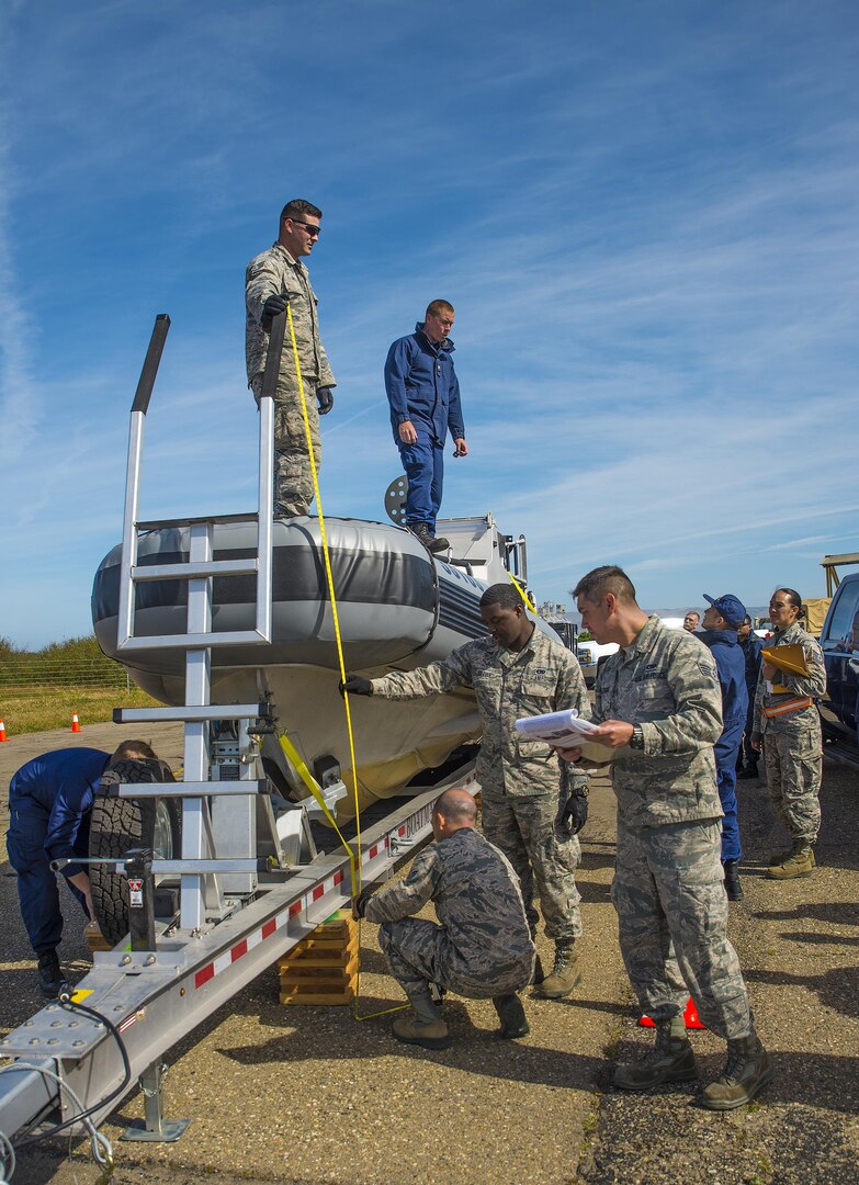 Airmen with the 26th Aerial Port Squadron weigh and measure a U.S. Coast Guard Transportable Port Security Boat before loading it onto a C-5M Super Galaxy aircraft during exercise Patriot Hook April 28, 2017 at Vandenberg Air Force Base, California.  Patriot Hook is an annual joint-service exercise coordinated by the Air Force Reserve, designed to integrate the military and first responders of federal, state and local agencies by providing training to mobilize quickly and deploying in military aircraft in the event of a regional emergency or natural disaster.  (U.S. Air Force photo by Benjamin Faske