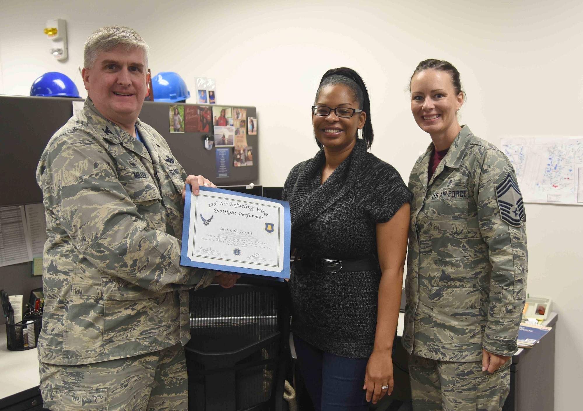 Melinda Forgit, 22nd Contracting Squadron contract specialist, poses with Col. Albert Miller, 22nd Air Refueling Wing commander, and Chief Master Sgt. Jamie Capps, 22nd Medical Group superintendent, April 21, 2017, at McConnell Air Force Base, Kan. Forgit received the spotlight performer for the week of April 10-14. (U.S. Air Force photo/Airman 1st Class Erin McClellan)