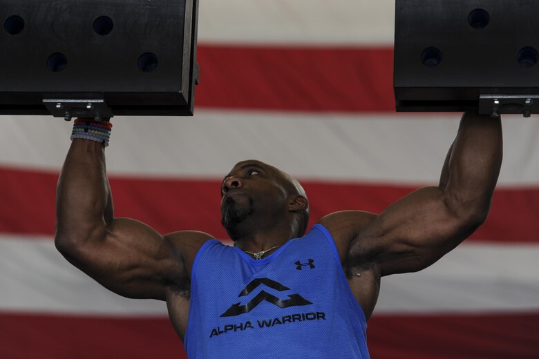 Bennie Wylie Jr., Alpha Warrior strength and conditioning coach, navigates through the cliffhanger obstacle at Hurlburt Field, Fla., April 29, 2017. Wylie led physical training prior to the Alpha Warrior battle rig competition and prepared participants for the upcoming challenges. (U.S. Air Force photo by Airman 1st Class Dennis Spain)