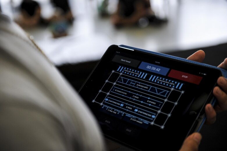 A member of the Alpha Warrior headquarters team keeps track of a contestant's time during the Alpha Warrior Battle Rig Competition at Hurlburt Field, Fla., April 29, 2017. Alpha Warrior is an obstacle competition similiar to that of the television competition show American Ninja Warrior. (U.S Air Force photo by Airman 1st Class Dennis Spain)
