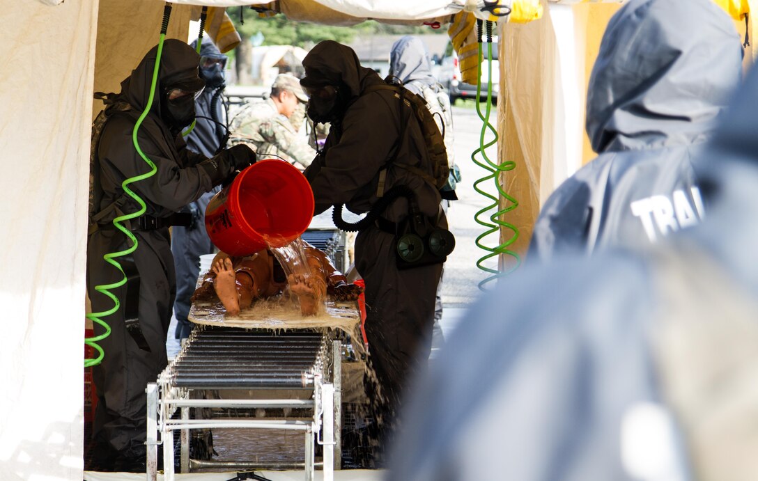 Soldiers from the 51st Chemical Company 83rd Battalion stationed in Fort Stewart, Ga., complete the final stages of decontamination on a scenario victim during a simulated improvised nuclear device explosion  April 29, 2017, as part of Guardian Response at Muscatatuck Urban Training Center, Ind. Exercise Guardian Response is a multi-component training exercise run by the U.S. Army Reserve designed to validate more than 4,000 service members in Defense Support of Civil Authorities (DSCA) in the event of a Chemical, Biological, Radiological and Nuclear (CBRN) catastrophe. This year's exercise simulated an improvised nuclear device explosion with a source region electromagnetic pulse (SREMP) out to more than four miles. The 84th Training Command is the hosting organization for this exercise, with the training operations run by the 78th Training Division, headquartered in Joint Base McGuire-Dix-Lakehurst, New Jersey. (U.S. Army Reserve Photo by Maj. Adam Weece, 206th Broadcast Operations Detachment)