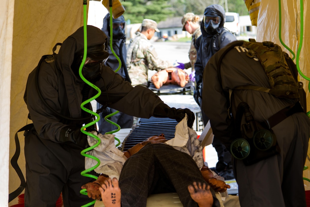 Soldiers from the 51st Chemical Company, 83rd Battalion, stationed in Fort Stewart, Ga., decontaminate a scenario victim before he can be assessed by medics April 29, 2017, as part of Exercise Guardian Response at Muscatatuck Urban Training Center, Ind. Guardian Response is a multi-component training exercise run by the U.S. Army Reserve designed to validate more than 4,000 service members in Defense Support of Civil Authorities (DSCA) in the event of a Chemical, Biological, Radiological and Nuclear (CBRN) catastrophe. This year's exercise simulated an improvised nuclear device explosion with a source region electromagnetic pulse (SREMP) out to more than four miles. The 84th Training Command is the hosting organization for this exercise, with the training operations run by the 78th Training Division, headquartered in Joint Base McGuire-Dix-Lakehurst, New Jersey. (U.S. Army Reserve Photo by Maj. Adam Weece, 206th Broadcast Operations Detachment)