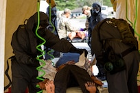 Soldiers from the 51st Chemical Company, 83rd Battalion, stationed in Fort Stewart, Ga., decontaminate a scenario victim before he can be assessed by medics April 29, 2017, as part of Exercise Guardian Response at Muscatatuck Urban Training Center, Ind. Guardian Response is a multi-component training exercise run by the U.S. Army Reserve designed to validate more than 4,000 service members in Defense Support of Civil Authorities (DSCA) in the event of a Chemical, Biological, Radiological and Nuclear (CBRN) catastrophe. This year's exercise simulated an improvised nuclear device explosion with a source region electromagnetic pulse (SREMP) out to more than four miles. The 84th Training Command is the hosting organization for this exercise, with the training operations run by the 78th Training Division, headquartered in Joint Base McGuire-Dix-Lakehurst, New Jersey. (U.S. Army Reserve Photo by Maj. Adam Weece, 206th Broadcast Operations Detachment)