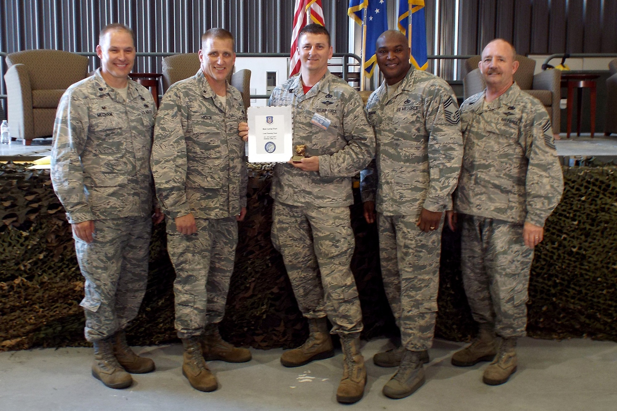 (Left to Right) U.S. Air Force Reserve Lt. Col. Keith Mecham, commander, 67th Aerial Port Squadron, Brig. Gen. John A. Hickok, deputy director of logistics, engineering and force protection, Headquarters Air Force Reserve Command, Master Sgt. Morgan Abner, 96th Aerial Port Squadron, Chief Master Sgt. Darius Drummond, air transportation career field manager, Headquarters Air Force, and Chief Master Sgt. Richard Hiney, Port Dawg Challenge Chief, and superintendent, 27th Aerial Port Squadron, pose for a photo after receiving the award for “Best Load Planning Team” during the 2017 Air Force Reserve Command Port Dawg Challenge awards ceremony April 27, 2017, at Dobbins Air Reserve Base, Ga. Twenty-three teams competed in 12 events over three days to showcase their air transportation skills. (U.S. Air Force photo by Tech. Sgt. Debra Gentry/Released)