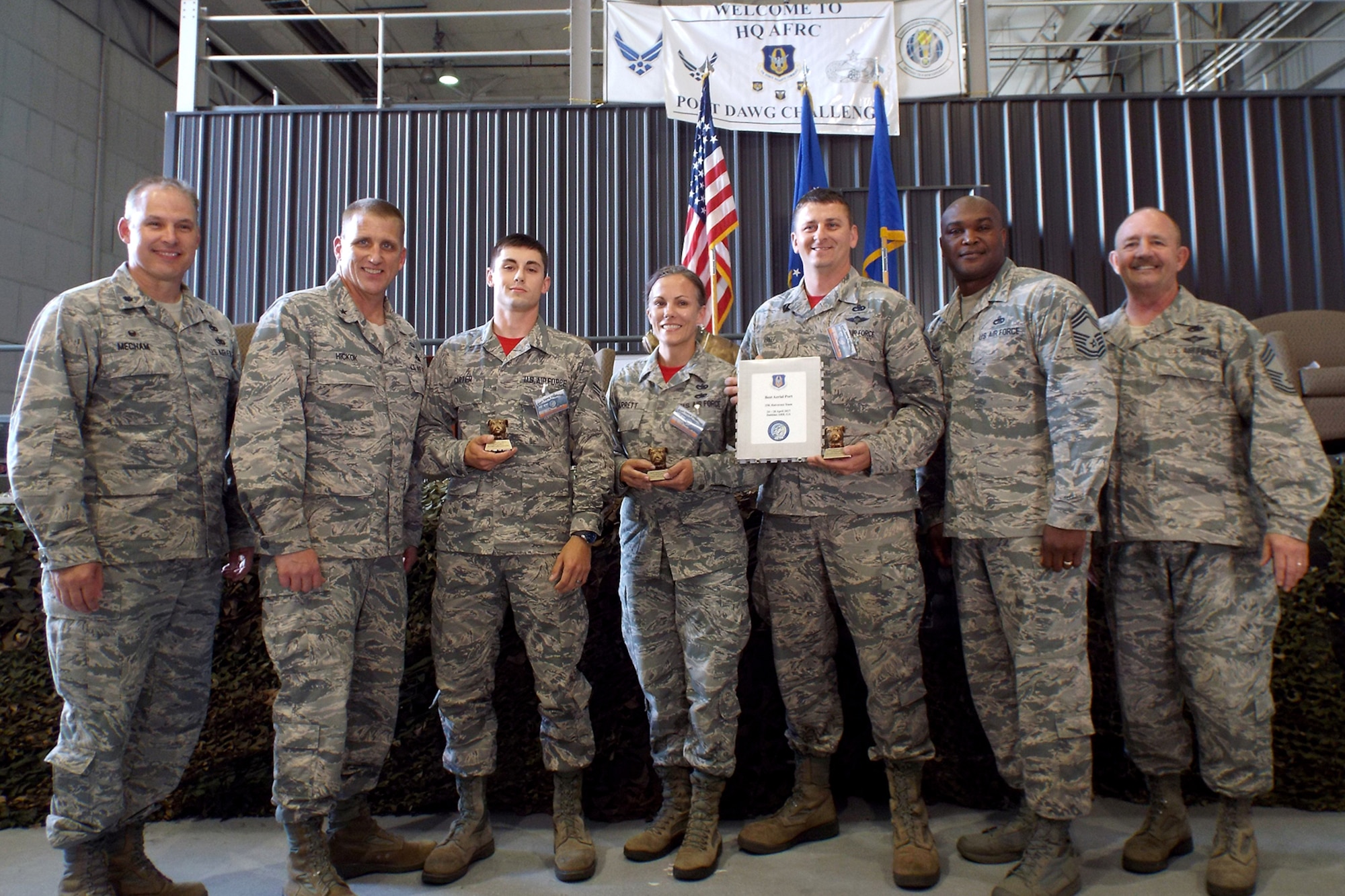 (Left to Right) U.S. Air Force Reserve Lt. Col. Keith Mecham, commander, 67th Aerial Port Squadron, Brig. Gen. John A. Hickok, deputy director of logistics, engineering and force protection, Headquarters Air Force Reserve Command, Senior Airman Jacob Carter, 96th Aerial Port Squadron, Tech Sgt. Kristen Garrett, 96th APS, Master Sgt. Morgan Abner, 96th APS, Chief Master Sgt. Darius Drummond, air transportation career field manager, Headquarters Air Force, and Chief Master Sgt. Richard Hiney, Port Dawg Challenge Chief, and superintendent, 27th Aerial Port Squadron, pose for a photo after receiving the award for “Best 25K Halvorsen Team” during the 2017 Air Force Reserve Command Port Dawg Challenge awards ceremony April 27, 2017, at Dobbins Air Reserve Base, Ga. Twenty-three aerial port teams competed in 12 events over three days to be recognized as the best in the air transportation field. (U.S. Air Force photo by Tech. Sgt. Debra Gentry/Released)