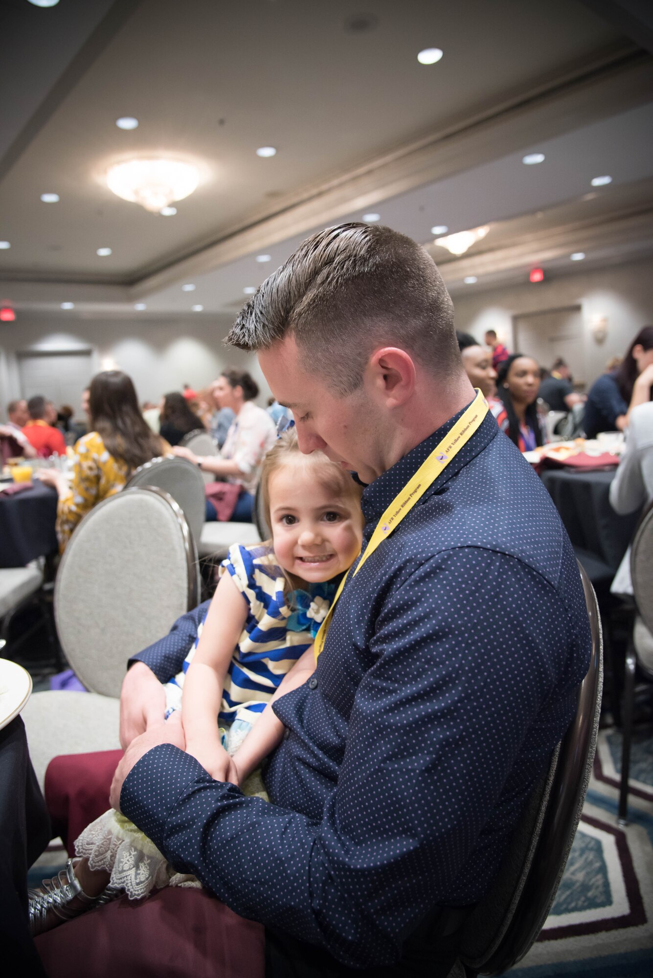 Staff Sgt. Timmothy Pettis, 916th Aircraft Maintenance Squadron crew chief holds his daughter Regan during a Yellow Ribbon program event in New Orleans, April 21-23. (U.S. Air Force photo by Staff Sgt. Heather Heiney)