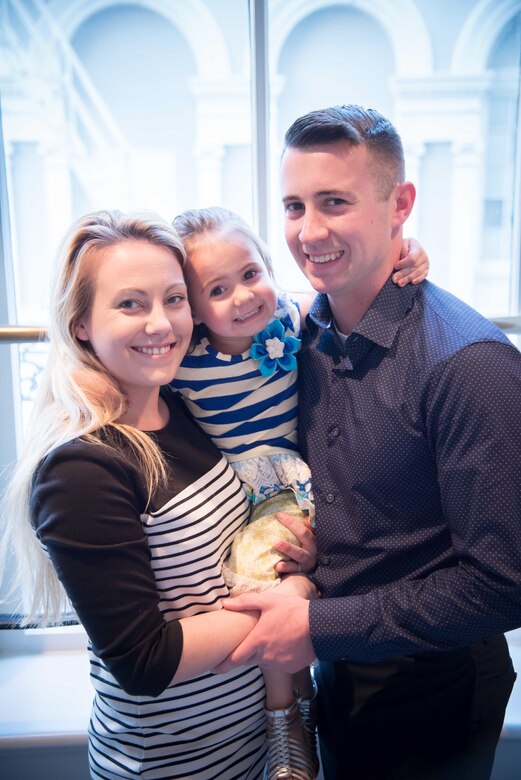 Staff Sgt. Timmothy Pettis, 916th Aircraft Maintenance Squadron crew chief, poses for a photo with his wife Devin and daughter Regan during a Yellow Ribbon program event in New Orleans April 21-23.(U.S. Air Force photo by Staff Sgt. Heather Heiney)