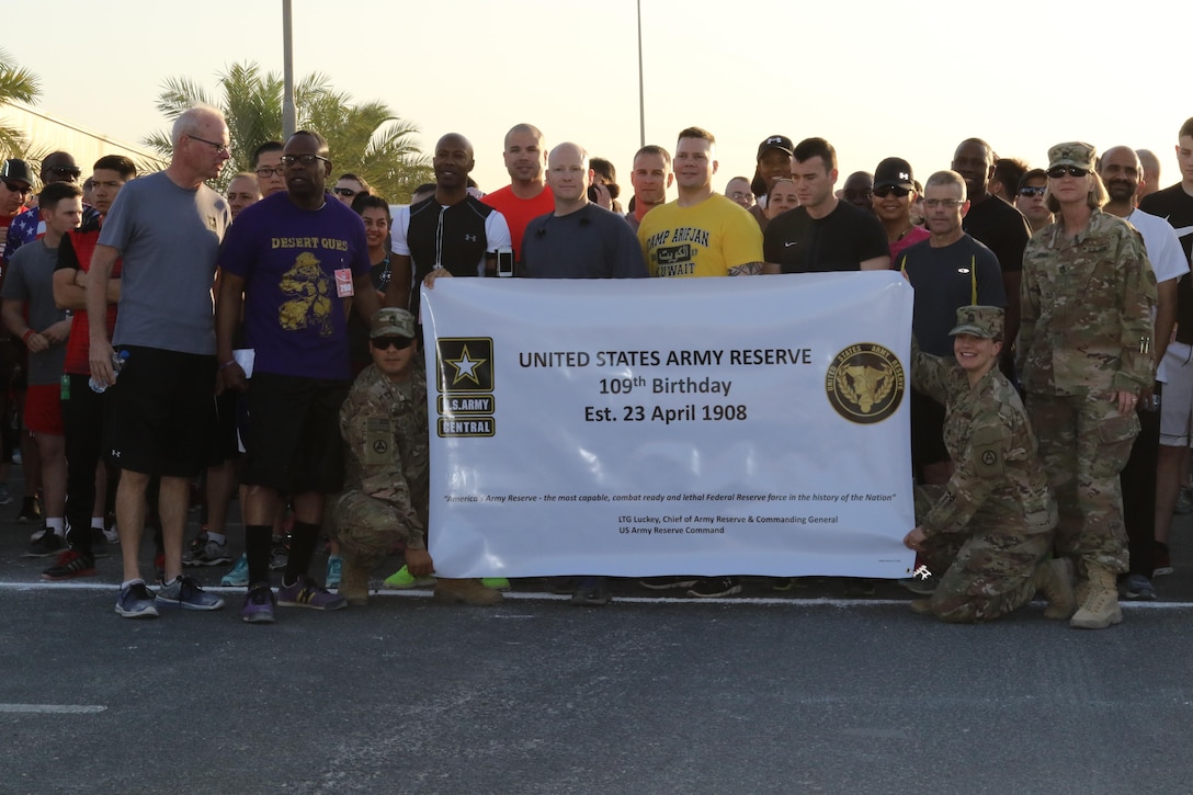 U.S. Servicemembers pose for a picture at the start of the Army Reserve 5k Walk or Run April 22, at Camp Arifjan, Kuwait. The Army Reserve Engagement Cell hosted this annual run as part of a celebratory day geared toward honoring the men and women who serve in the U.S. Army Reserves.