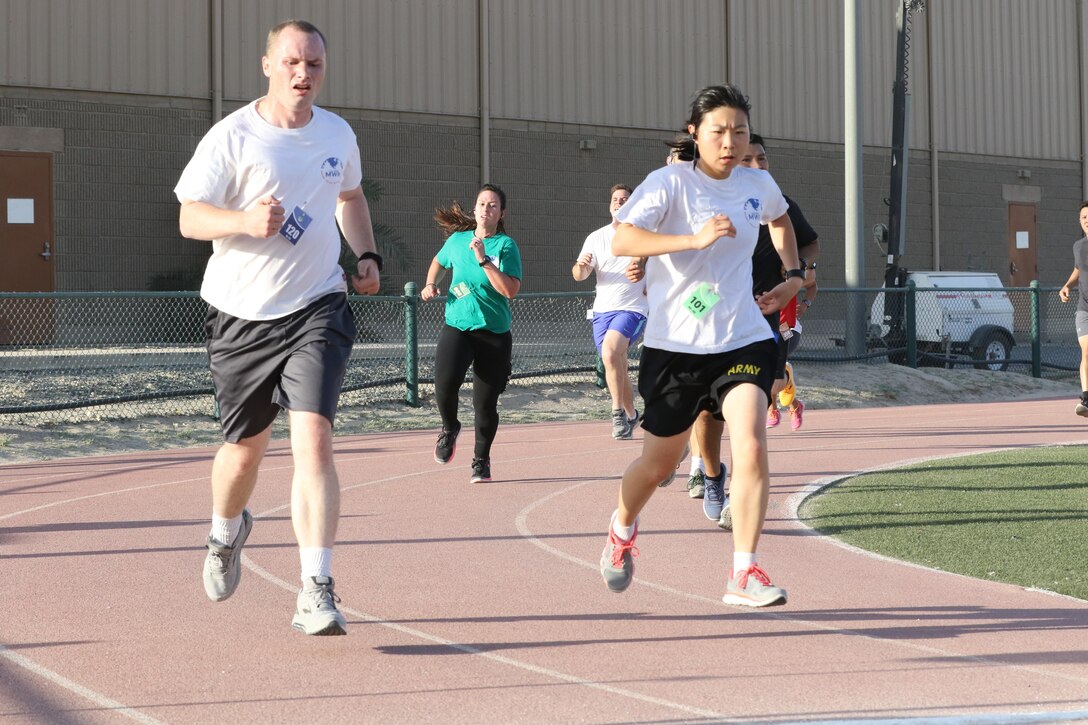 U.S. Servicemembers dash to the finish line at the Army Reserve 5k Walk or Run, April 22, at Camp Arifjan, Kuwait. The Army Reserve Engagement Cell hosted this annual event, as part of a celebratory day geared to honoring the men and women who serve in the U.S. Army Reserve.