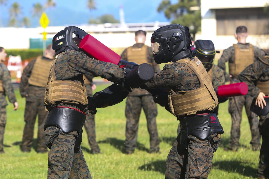 Marines spar at the pugil sticks station during a martial arts instructor course at Marine Corps Base Hawaii, May 1, 2017. Marine Corps photo by Cpl. Zachary Orr