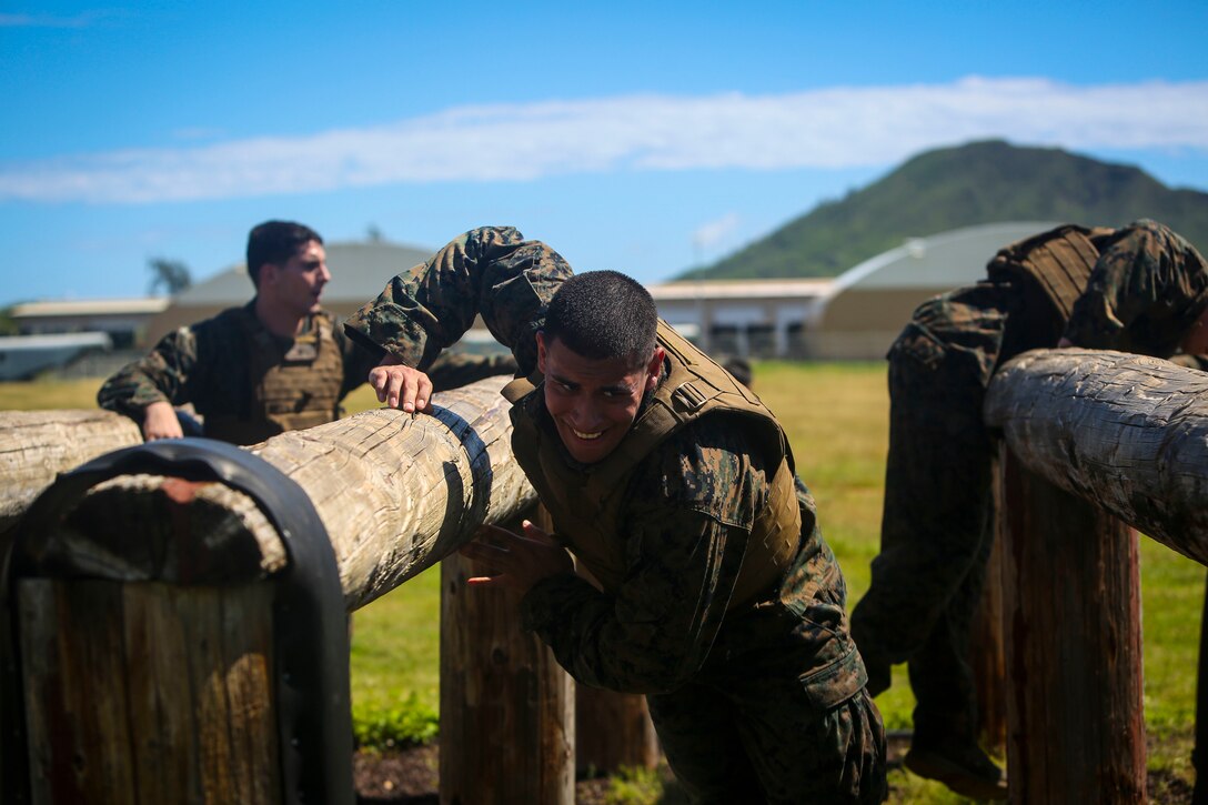 Marines scale logs during the obstacle course portion of a martial arts instructor course at Marine Corps Base Hawaii, May 1, 2017. Marine Corps photo by Cpl. Zachary Orr