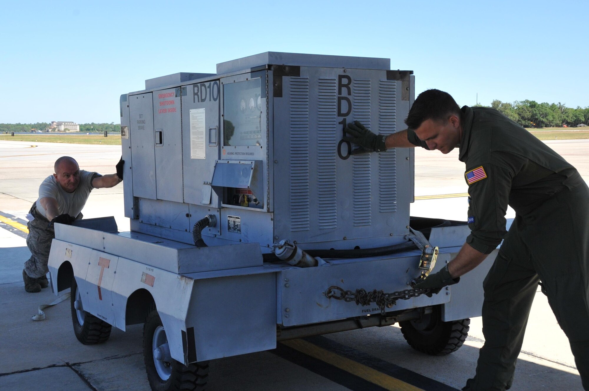 Staff Sgt. Nathan Calloway, 53rd Weather Reconnaissance Squadron loadmaster, and Staff Sgt. Bret Christofferson, 41st Aerial Port Squadron air transportation specialist, manually move an RD-10 generator in place to be loaded onto the WC-130J, May 1, 2017 at Keesler Air Force Base, Mississippi. The cargo is for the annual St. Croix "Roll-out" to ensure equipment and supplies are available in the forward operating location in the event of a hurricane.  (U.S. Air Force photo// Master Sgt. Jessica Kendziorek)