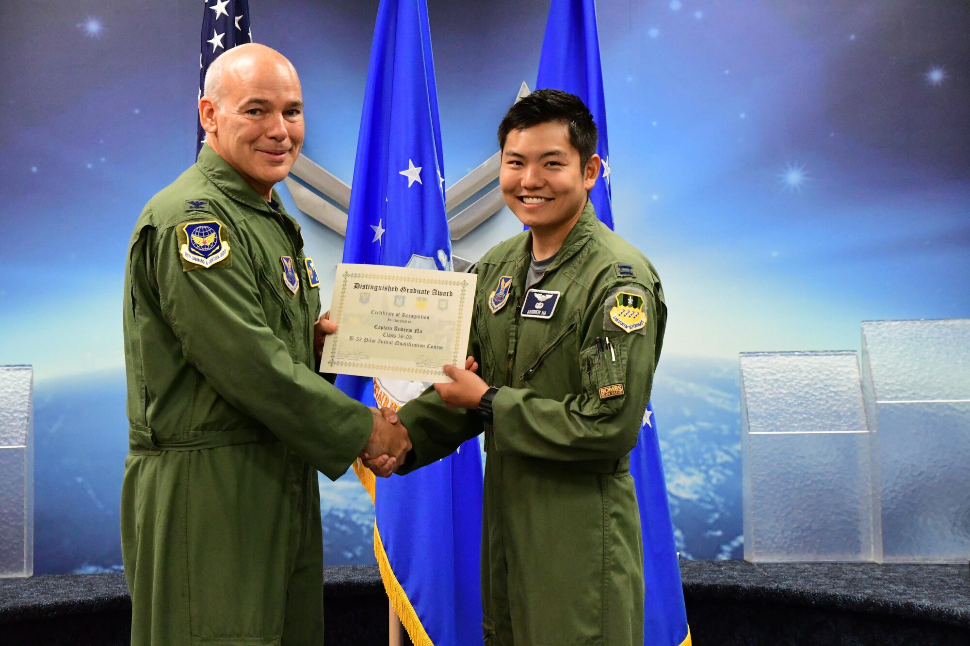 Col. Patrick Matthews, Eighth Air Force vice commander, presents the Pilot Distinguished Graduate Award to Capt. Andrew Na during a Formal Training Unit graduation ceremony April 28, 2017, at Barksdale Air Force Base, La. Na graduated from the FTU as a pilot on the B-52H Stratofortress. (U.S. Air Force photo by Master Sgt. Dachelle Melville/Released)