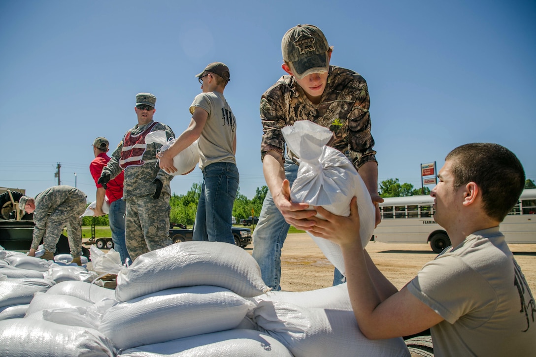 Missouri Army National Guardsmen move sandbags with the help of community members in Poplar Bluff, Mo., May 2, 2017.  Air National Guard photo by Staff Sgt. Colton Elliott