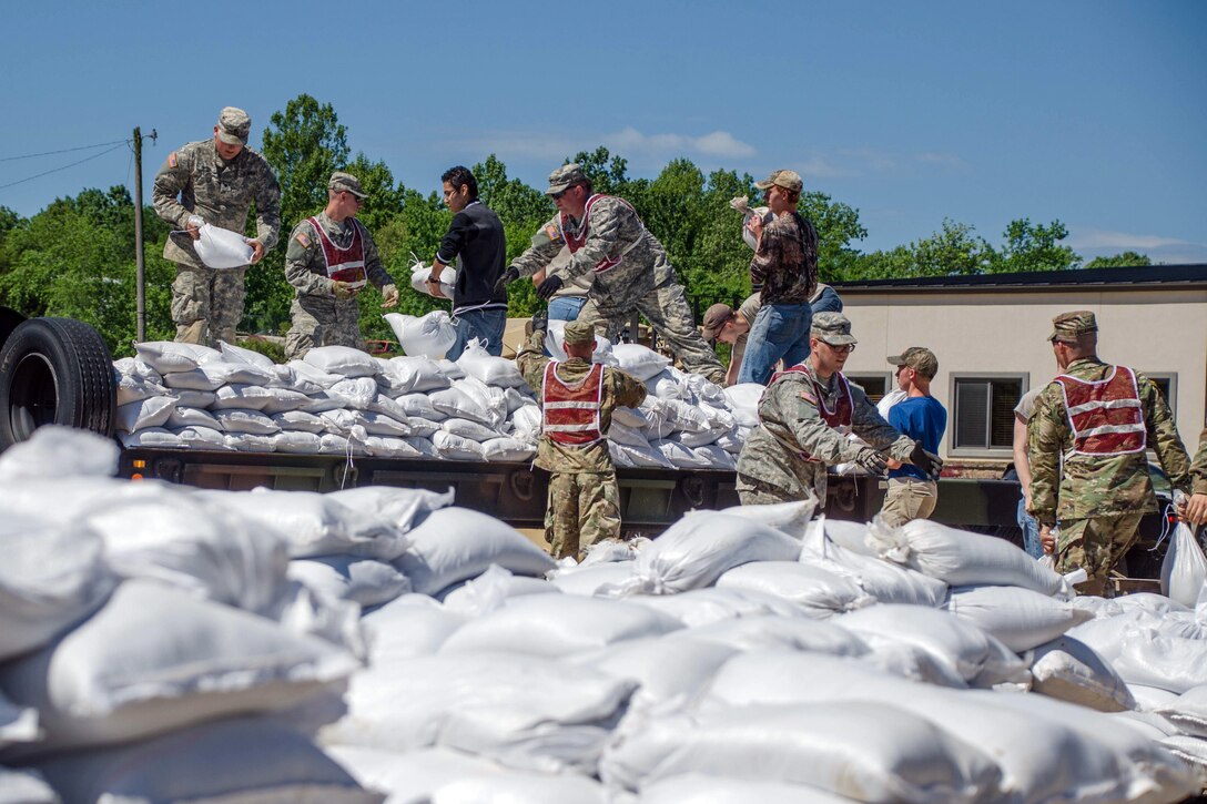 Missouri National Guardsmen work with volunteers to move sandbags in Poplar Bluff, Mo., May 2, 2017.  Air National Guard photo by Staff Sgt. Colton Elliott