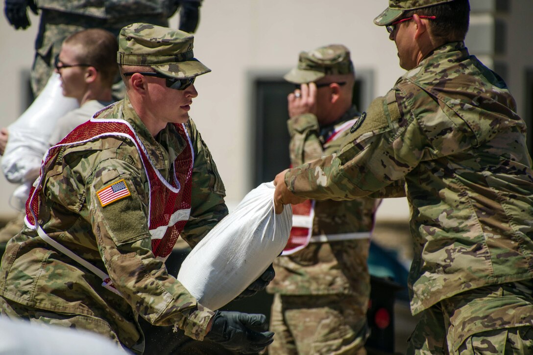 Missouri National Guardsmen fill and carry sandbags in Poplar Bluff, Mo., May 2, 2017. About 40 soldiers filled approximately 4,800 bags to support a levy at risk of breaking. The soldiers are assigned to the 1138th Engineer Company. Air National Guard photo by Staff Sgt. Colton Elliott