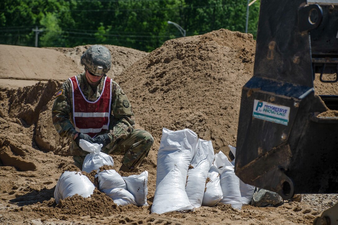 A soldier assigned to the Missouri National Guard’s 1138th Engineer Company fills sandbags in Poplar Bluff, Mo., May 2, 2017. Air National Guard photo by Staff Sgt. Colton Elliott