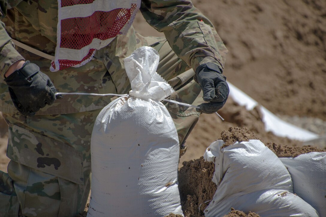 Missouri National Guardsmen fill sandbags in Poplar Bluff, Mo., May 2, 2017. More than 40 soldiers worked to fill 4,800 sandbags with more than 150 tons of sand in response to extreme flooding in the region. Air National Guard photo by Staff Sgt. Colton Elliott