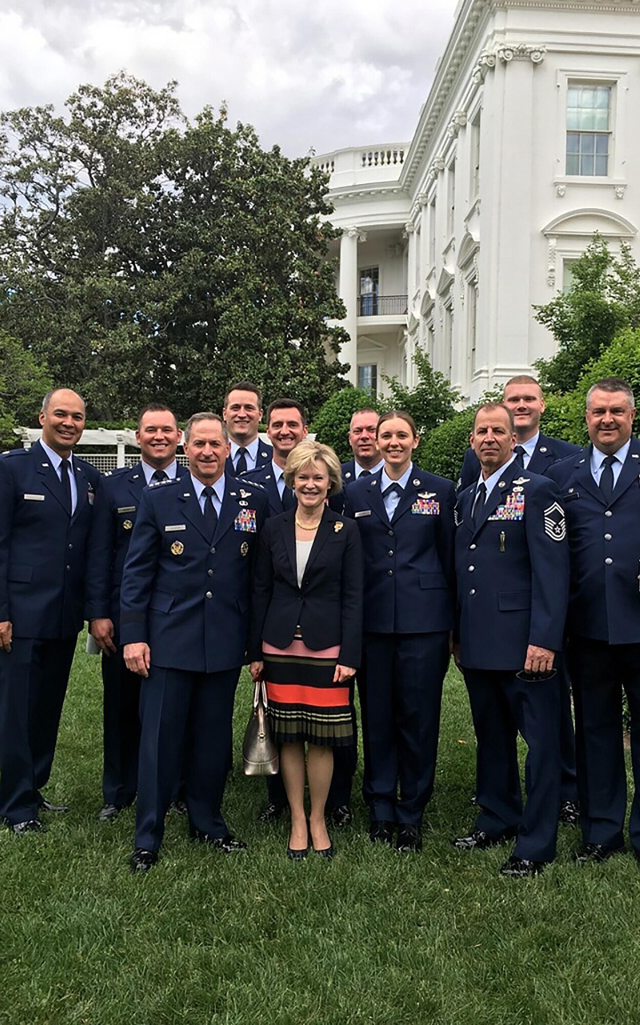 Air Force Chief of Staff Gen. David L. Goldfein and his wife, Dawn pose with the 89th Airlift Squadron aircrew outside the White House May 2, 2017. From left to right; Lt. Col. Wed Sendaydiego, pilot, Capt. Shaun Carney, pilot, Staff Sgt. Jason Benedict, loadmaster, Capt. Ryan Armstrong, pilot, Tech. Sgt. Bill Burdick, 445th Aircraft Maintenance Squadron crew chief, Master Sgt. Danielle Kremer, loadmaster, Senior Master Sgt. Craig Essert, loadmaster, Senior Airman Mike Logan, 445th AMXS crew chief and Lt. Col. William Gorczynski, 89th AS commander. The 445th Airlift Wing’s 89th AS flew the Air Force Academy football team from Colorado Springs, Colorado to Washington, D.C., to accept the Commander in Chief’s Trophy from President Donald Trump at the White House May 2, 2017. (Courtesy photo)