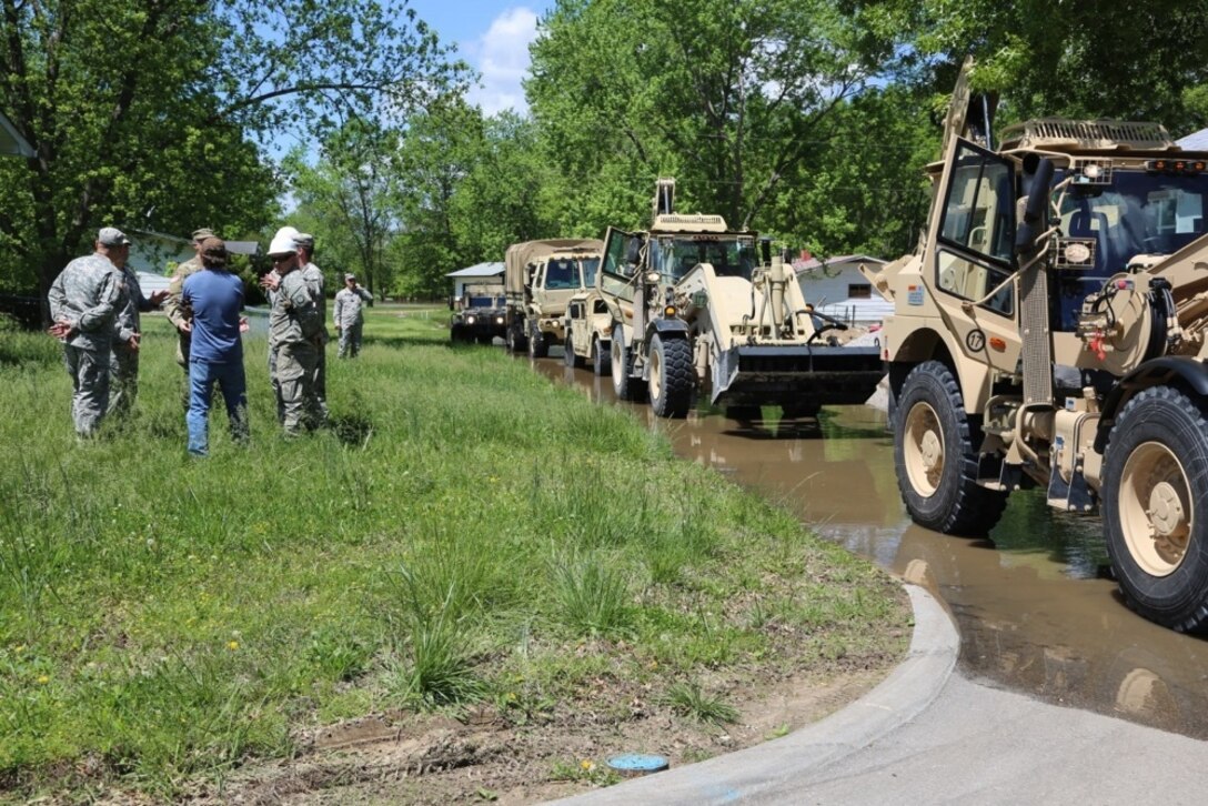 Missouri Army National Guard 220th Engineer Company arrives in Arnold, Mo. with heavy equipment to support the local community and place sandbags around the subdivision to hold back flood waters May 2, 2017. Army National Guard photo by PFC Garrett Bradley