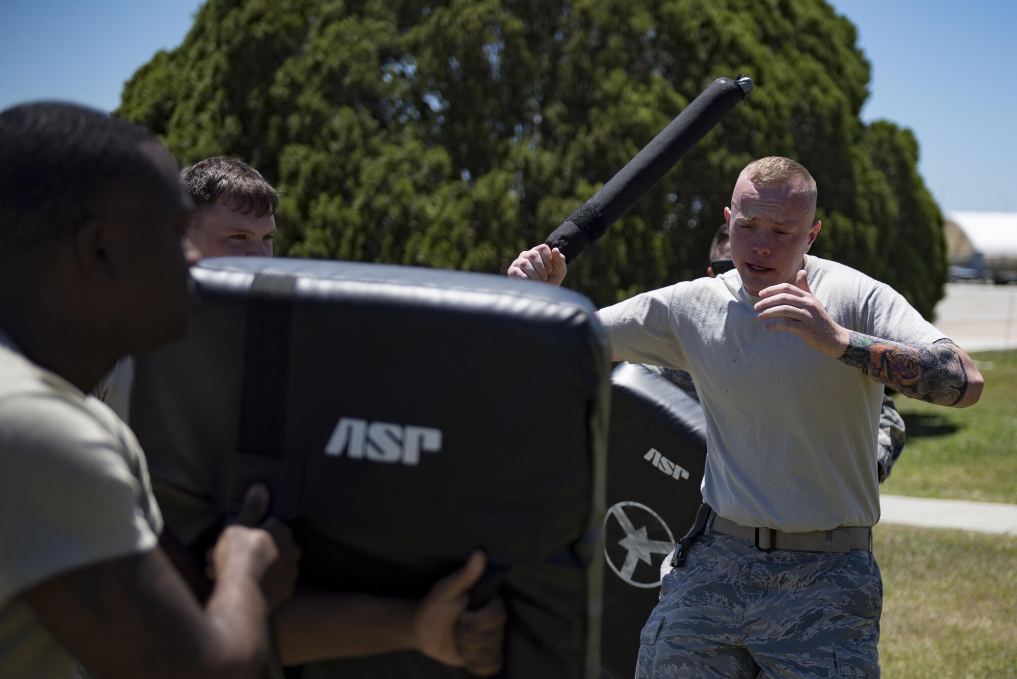 Airman 1st Class Hunter Ogle, 23d Security Forces Squadron entry controller, attacks simulated enemies after being sprayed in the face with oleoresin capsicum spray, also known as pepper spray, during an initial confidence course, May 2, 2017, at Moody Air Force Base, Ga. Airmen must complete a class then pass a physical confidence course while experiencing the effects of oleoresin capsicum spray to be qualified to carry the less-than-lethal tool. (Air Force photo by Airman 1st Class Daniel Snider)