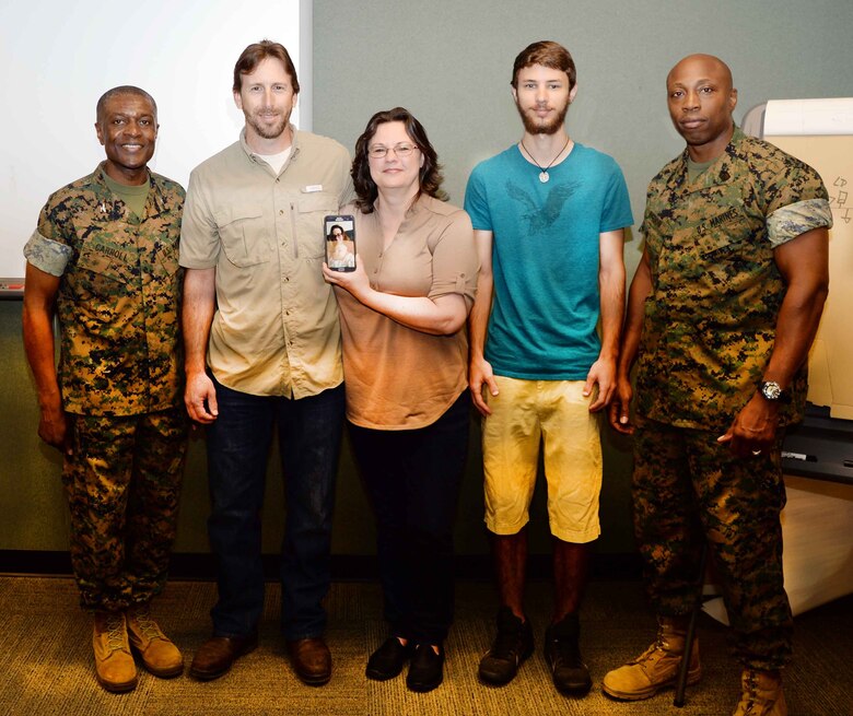 Brian Cox (second from left), work leader, Heating, Ventilation and Air Conditioning, Public Works Branch, Marine Corps Logistics Base Albany, receives the Marine Corps Installations EAST, 2016 Civilian of the Year Award in a ceremony, here, recently. Col. James C. Carroll III (left), commanding officer, assisted by Sgt. Maj. Johnny Higdon (right), sergeant major, MCLB Albany, presented the commendation on behalf of Brig. Gen. Thomas Weidley, commanding general, MCIEAST, Camp Lejeune, N.C. Cox’s family members also attended the event.