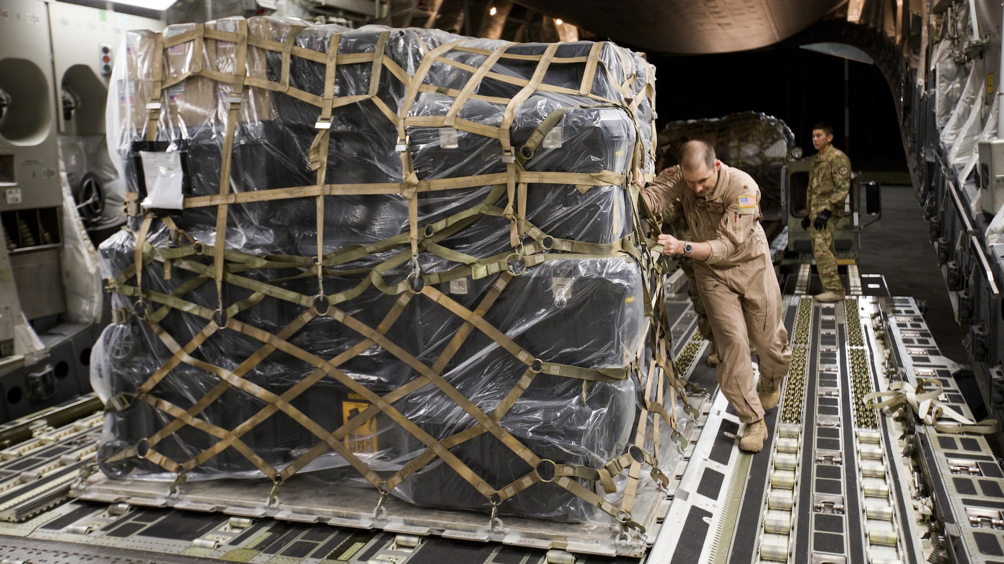 U.S. Air Force Maj. Robert Riggs, U.S. Marine Corps Forces, Special Operations Command air mobility liaison officer (AMLO), assists in loading cargo aboard a C-17 aircraft at MCAS Cherry Point. As MARSOC’s AMLO, Riggs provides a critical link of communication between the airlift and ground forces in the area of operations. He facilitated the mission from planning and coordination through hands-on facilitation by piloting the aircraft as it deployed and re-deployed two MARSOC units. (U.S. Marine Corps photo by Sgt. Salvador Moreno, released)