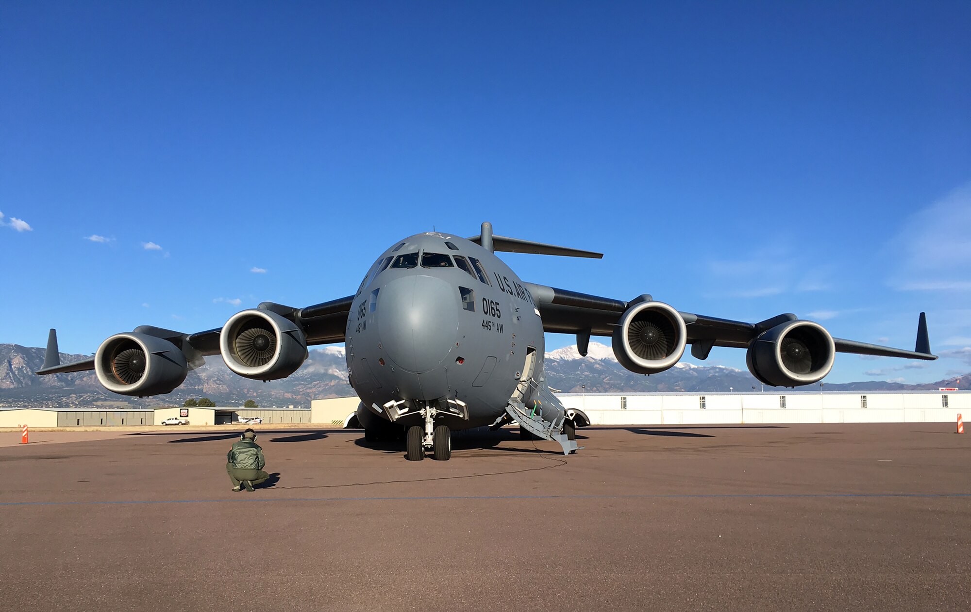 The mountains of Colorado provide the perfect backdrop to a 445th Airlift Wing C-17 Globemaster III as it sits on the flightline in Colorado Springs, Colorado in preparation for flying home to Ohio. The inherent flexibility and performance of the C-17 force improve the ability of the total airlift system to fulfill the worldwide air mobility requirements of the United States. (Courtesy photo)