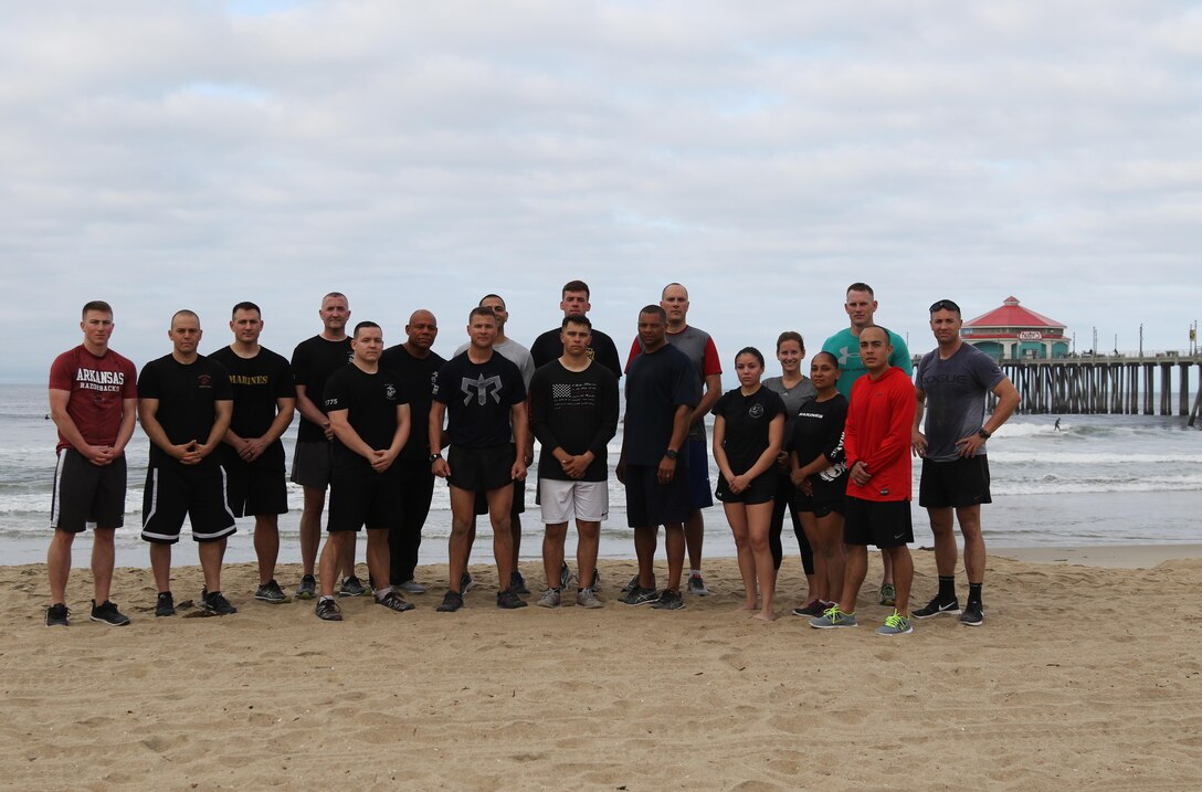 U.S. Marines of Recruiting Station Orange County and 12th Marine Corps District pose together after completing a team-building workout at Huntington Beach, Calif., April 18, 2017. (U.S. Marine Corps photo by Sgt. Jessica Quezada)