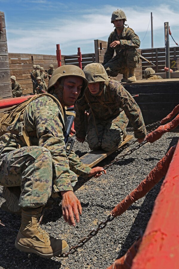 Officer Candidates of Recruiting Station Orange County, Recruiting Station Los Angeles, Recruiting Station San Diego and Recruiting Station Riverside, maneuver through the leadership reaction course during the Officer Candidate School preparation weekend at Camp Pendleton, Calif., April 22, 2017. In order to prepare applicants for the rigors of OCS, this weekend-long training evolution assists in conditioning and familiarization with the types of endeavors candidates will face at the school.(U.S. Marine Corps photo by Sgt. Jessica Quezada)