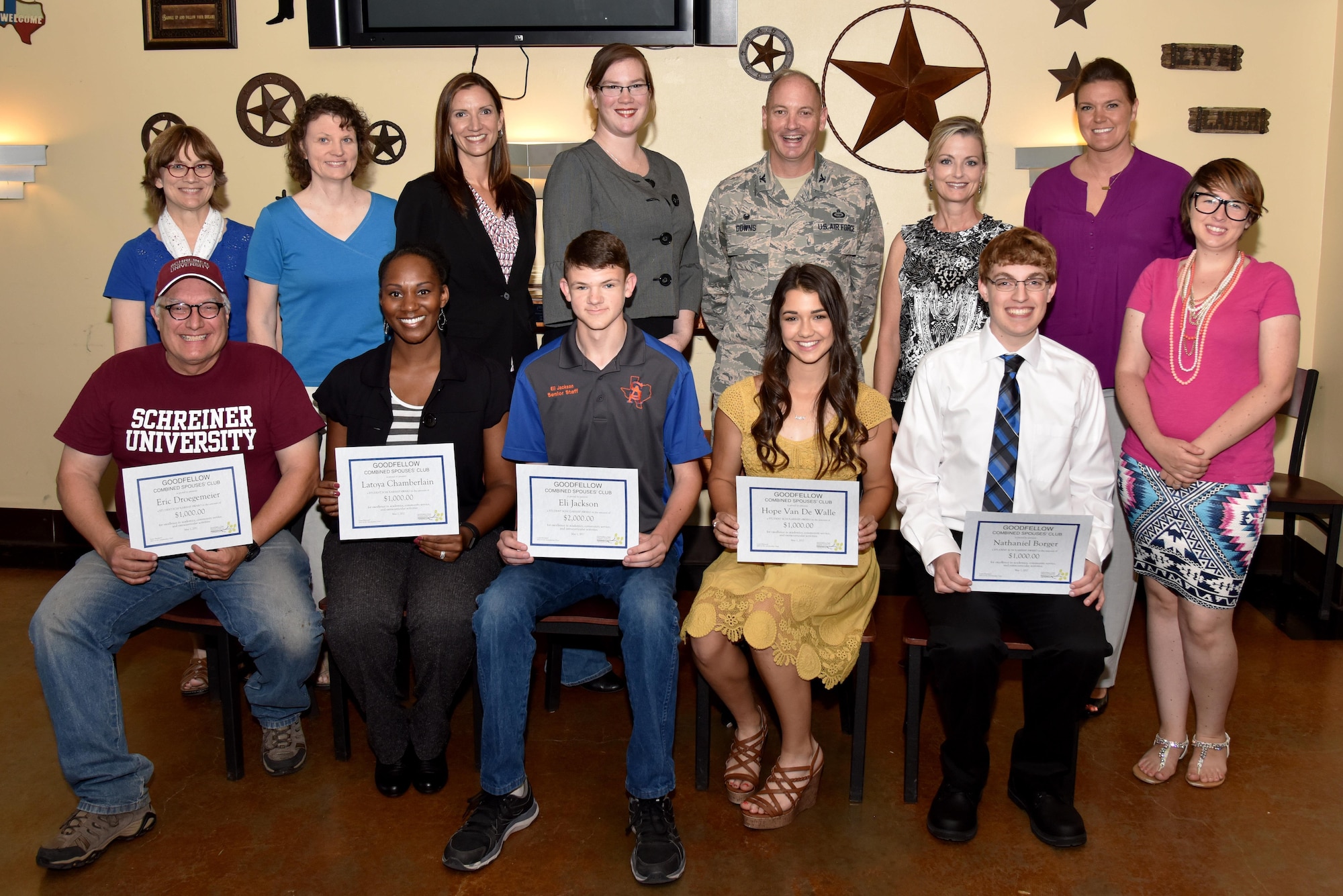 Goodfellow Combined Spouses’ Club Scholarship award winners pose with U.S. Air Force Col. Michael Downs, 17th Training Wing Commander, and GCSC members after a scholarship award ceremony at the Event Center on Goodfellow Air Force Base, Texas, May 1, 2017. Each winner wrote an essay about their goals and how being a military dependent has affected them. (U.S. Air Force photo by Staff Sgt. Joshua Edwards/Released)