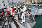 Lt. j.g. Kevin Spillane answers a question about the ship's anchor chain from a tour group visiting the Arleigh Burke-class guided missile destroyer USS Sterett (DDG 104) during the ship's port visit to Hong Kong, May 1, 2017. Sterett is part of the Sterett-Dewey Surface Action Group operating under the command and control construct called 3rd Fleet Forward.