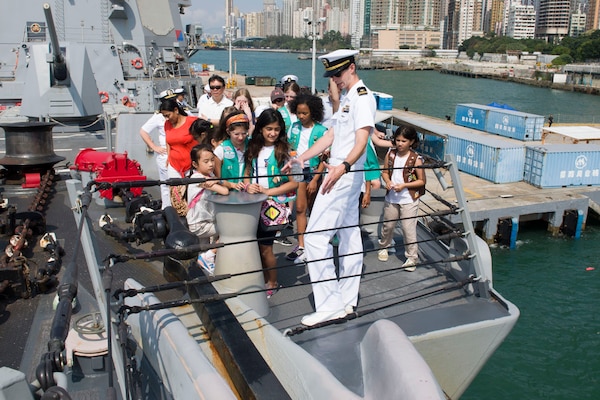 Lt. j.g. Kevin Spillane answers a question about the ship's anchor chain from a tour group visiting the Arleigh Burke-class guided missile destroyer USS Sterett (DDG 104) during the ship's port visit to Hong Kong, May 1, 2017. Sterett is part of the Sterett-Dewey Surface Action Group operating under the command and control construct called 3rd Fleet Forward.