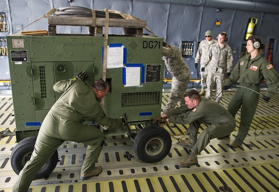 Airmen with the 68th Airlift Squadron prepare to offload a generator from a C-5M Super Galaxy aircraft during exercise Patriot Hook April 26, 2017 at Vandenberg Air Force Base, California. Patriot Hook is an annual joint-service exercise coordinated by the Air Force Reserve, designed to integrate the military and first responders of federal, state and local agencies by providing training to mobilize quickly and deploying in military aircraft in the event of a regional emergency or natural disaster. (U.S. Air Force photo by Benjamin Faske)