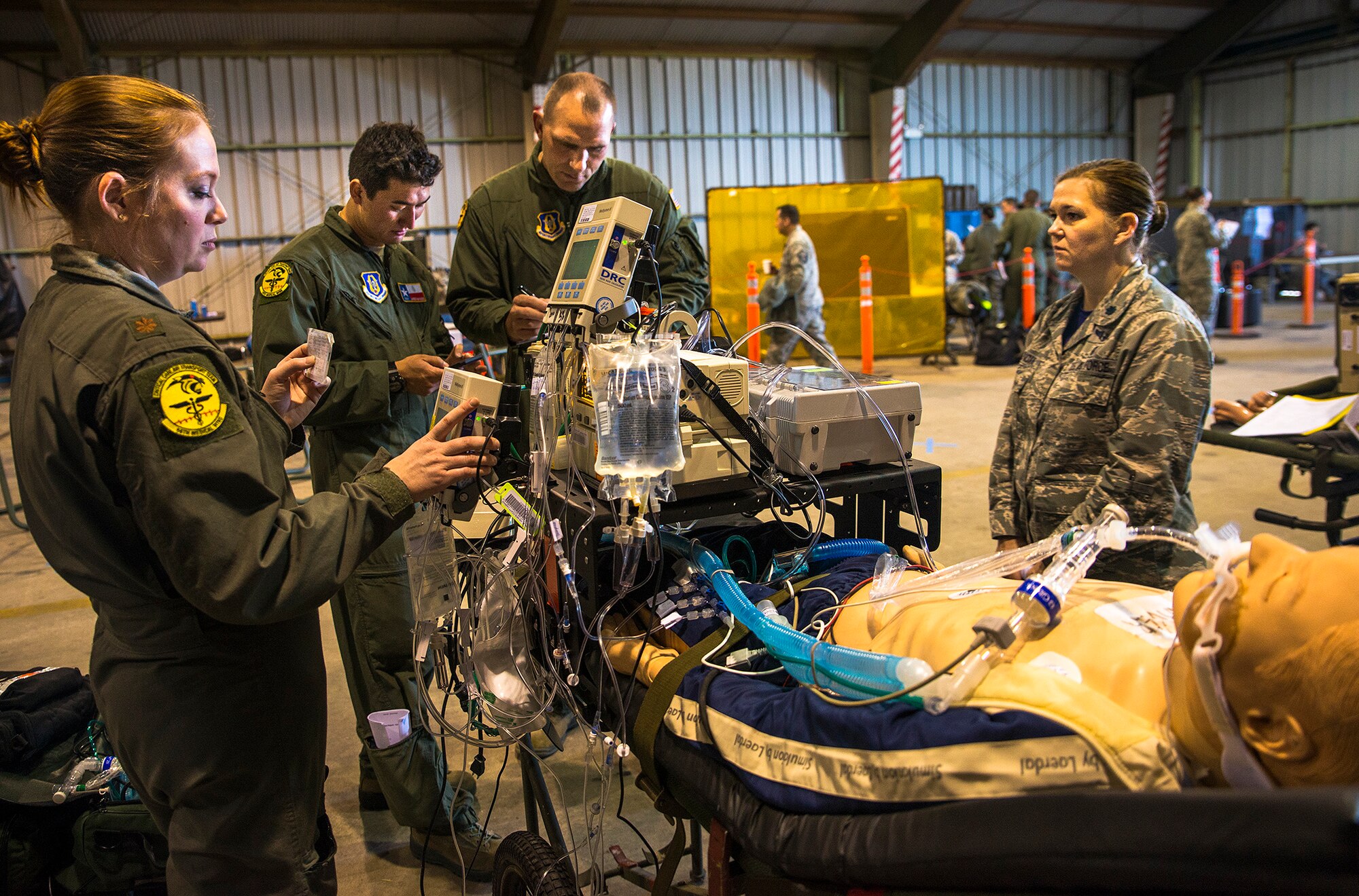 Maj. Dana Mayer, Tech. Sgt. James Bayless, and Maj. Gary Barder, 433rd Medical Squadron critical care air transport team, use a portable ICU to stabalize a simulated patient before loading them onto a C-130 Hercules aircraft from Youngstown Air Reserve Station, Ohio during exercise Patriot Hook April 28, 2017 at Vandenberg Air Force Base. Patriot Hook is an annual joint-service exercise coordinated by the Air Force Reserve, designed to integrate the military and first responders of federal, state and local agencies by providing training to mobilize quickly and deploying in military aircraft in the event of a regional emergency or natural disaster. (U.S. Air Force photo by Benjamin Faske)